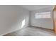 Spacious bedroom featuring a large window and light wood laminate floors at 2832 S Oakland Ave, Indianapolis, IN 46203