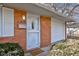 White front door with security screen and welcome mat at 2832 S Oakland Ave, Indianapolis, IN 46203