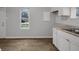Updated kitchen with white cabinets and vinyl flooring at 2875 Adams St, Indianapolis, IN 46218