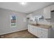Renovated kitchen featuring white cabinets and new flooring at 2875 Adams St, Indianapolis, IN 46218