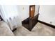 Basement access stairs showing wood railings and access to natural light through the window at 403 Colescott St, Shelbyville, IN 46176