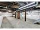 Unfinished basement with exposed ceiling beams, concrete floor, and white-painted walls at 403 Colescott St, Shelbyville, IN 46176
