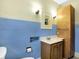 This bathroom features blue tile on the walls and a wood vanity at 403 Colescott St, Shelbyville, IN 46176