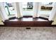 Close-up of a bay window seat with wood trim and view of the neighborhood, covered in carpet at 403 Colescott St, Shelbyville, IN 46176
