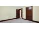Bedroom with neutral walls and carpet featuring two doors and window at 403 Colescott St, Shelbyville, IN 46176