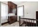Upstairs hallway showing vintage wooden cabinets and two windows with white curtains at 403 Colescott St, Shelbyville, IN 46176