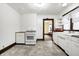 Efficient kitchen with white cabinetry, vintage detailing, and an open layout offering access to other rooms at 403 Colescott St, Shelbyville, IN 46176