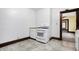 Bright kitchen with white cabinetry and neutral tile flooring, equipped with modern appliances, and wooden trim at 403 Colescott St, Shelbyville, IN 46176