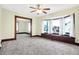 Open living room with neutral carpet, natural lighting, and a built-in bench under a large bay window at 403 Colescott St, Shelbyville, IN 46176