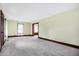 Spacious living room with plush gray carpeting and classic dark wood trim at 403 Colescott St, Shelbyville, IN 46176