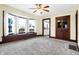 Bright living room featuring a bay window with bench seating, ceiling fan, and decorative wood trim at 403 Colescott St, Shelbyville, IN 46176