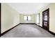 Bright living room featuring plush carpeting, neutral walls, and classic wood trim at 403 Colescott St, Shelbyville, IN 46176