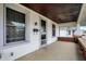 Inviting covered porch with classic columns and view of neighboring homes at 403 Colescott St, Shelbyville, IN 46176