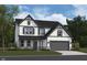 Two-story house with gray and white siding, a gray garage door, and landscaping at 552 Bluestem Ln, New Whiteland, IN 46184