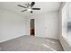 Bright bedroom with ceiling fan, grey carpet, and access to a bathroom at 573 New Moon St, Avon, IN 46123