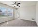 Spacious bedroom with ceiling fan, grey carpet, and access to backyard at 573 New Moon St, Avon, IN 46123