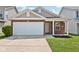 Brick and shingle ranch home with attached garage and landscaping at 573 New Moon St, Avon, IN 46123