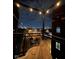 Relaxing balcony with overhead string lights offering a view of the city skyline at nighttime at 630 N College Ave # 401, Indianapolis, IN 46204