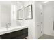 Modern bathroom with double vanity, black cabinets, and hexagon floor tile at 630 N College Ave # 401, Indianapolis, IN 46204