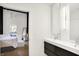 Clean bathroom with double vanity and view into bedroom at 630 N College Ave # 401, Indianapolis, IN 46204