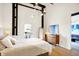 Spacious bedroom with exposed beams, hardwood floors, and private balcony access at 630 N College Ave # 401, Indianapolis, IN 46204