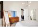 Bright bedroom with hardwood floors, mid-century dresser, and access to a private balcony at 630 N College Ave # 401, Indianapolis, IN 46204