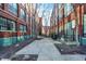 Landscaped courtyard with trees and a pathway between buildings at 630 N College Ave # 401, Indianapolis, IN 46204