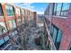 Brick building courtyard with trees and a paved pathway at 630 N College Ave # 401, Indianapolis, IN 46204