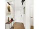 Bright entryway with hardwood floors and modern console table at 630 N College Ave # 401, Indianapolis, IN 46204
