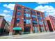 Brick building with large windows and green awning at 630 N College Ave # 401, Indianapolis, IN 46204