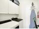 Convenient laundry room with washer, dryer, and overhead cabinets at 630 N College Ave # 401, Indianapolis, IN 46204