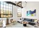 Bright and airy living room with large windows and stylish furniture at 630 N College Ave # 401, Indianapolis, IN 46204