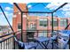 Private balcony with city view, table, chairs, and grill at 630 N College Ave # 401, Indianapolis, IN 46204