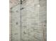 Elegant shower with marble tile and frameless glass enclosure at 630 N College Ave # 401, Indianapolis, IN 46204