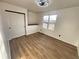 Bright bedroom features wood floors, a closet, and large window offering natural light at 6775 N County Road 550 E, Brownsburg, IN 46112