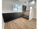 Inviting entryway features wood-look floors, black brick accents, and a staircase at 6775 N County Road 550 E, Brownsburg, IN 46112