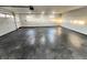 Spacious, clean garage featuring an epoxy floor, natural lighting, and a garage door at 6775 N County Road 550 E, Brownsburg, IN 46112