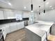Modern kitchen featuring white cabinets, stainless steel appliances, and an eat-in island at 6775 N County Road 550 E, Brownsburg, IN 46112