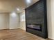 Modern living room with a sleek, built-in electric fireplace and light wood-look floors at 6775 N County Road 550 E, Brownsburg, IN 46112