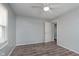 Bedroom with hardwood floors, natural light, a ceiling fan, light blue colored walls and a doorway at 711 W 24Th St, Anderson, IN 46016