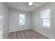 Comfortable bedroom with natural light, ceiling fan, hardwood-look floors, and neutral walls at 711 W 24Th St, Anderson, IN 46016