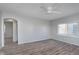 Bedroom featuring a ceiling fan, large windows, and hardwood floors at 711 W 24Th St, Anderson, IN 46016