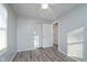 Bedroom features wood-look floors, neutral paint, closet, bright windows, and ceiling fan at 711 W 24Th St, Anderson, IN 46016