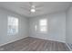 Bedroom with hardwood floors, natural light, a ceiling fan, and light blue colored walls at 711 W 24Th St, Anderson, IN 46016