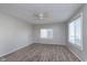 Bedroom featuring a ceiling fan, large windows, and hardwood floors at 711 W 24Th St, Anderson, IN 46016