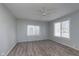 Bedroom featuring a ceiling fan, large windows, and hardwood floors at 711 W 24Th St, Anderson, IN 46016