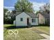 Single-story house with a well-kept lawn, a bright red door, and a cozy appeal at 711 W 24Th St, Anderson, IN 46016