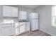 Clean kitchen with bright white cabinets, marble-look counters, and new refrigerator with wood-look floors at 711 W 24Th St, Anderson, IN 46016
