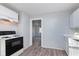 Cozy kitchen with range, white cabinets and marble-look countertops with gray walls and wood-look floors at 711 W 24Th St, Anderson, IN 46016