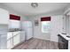 Functional kitchen featuring white appliances, modern flooring, and plenty of counter space at 711 W 24Th St, Anderson, IN 46016